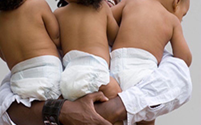 Father holding set of triplets Image 